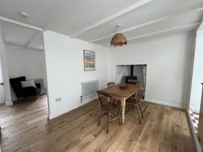 a dining room with a table and a fireplace at 9 Mount Pleasant in St Ives