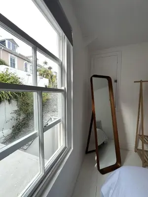 a mirror in a room next to a window at 9 Mount Pleasant in St Ives