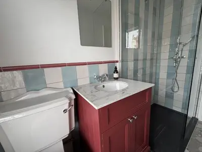 a bathroom with a red sink and a shower at 9 Mount Pleasant in St Ives