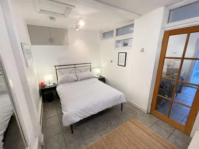 a small bedroom with a bed and a window at Step n Sea - moments from the town centre and sea in St Ives