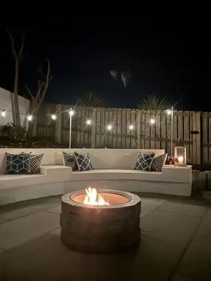 a fire pit in the middle of a patio at night at Holiday home with incredible sea views in Mevagissey