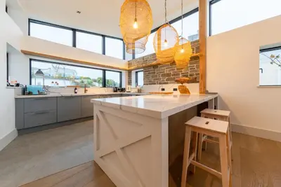 a kitchen with a large island in the middle at Holiday home with incredible sea views in Mevagissey