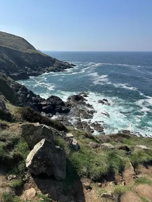 a view of the ocean from a hill with rocks at Luxury, Tranquillity Near Beach in Carbis Bay