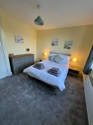 a bedroom with a bed with two pillows on it at Luxury, Tranquillity Near Beach in Carbis Bay