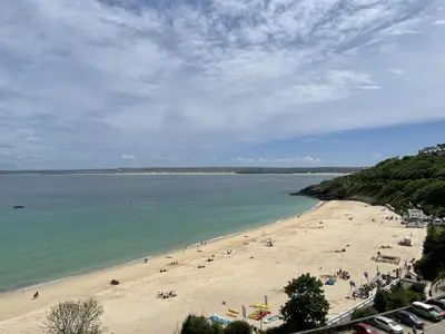a beach with a bunch of people on it at 36 Carrack Widden in St Ives