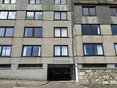 a large brick building with a garage at 36 Carrack Widden in St Ives