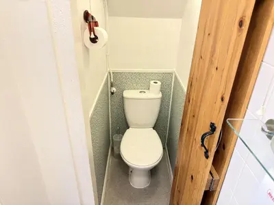 a bathroom with a toilet in a small room at Surfers Nest a modern fisherman lodge in St Ives