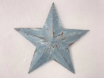 a blue star hanging on a wall at Surfers Nest a modern fisherman lodge in St Ives