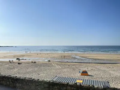 a view of a beach with people and the ocean at 4 Crusoes - beachside apartment in St Ives