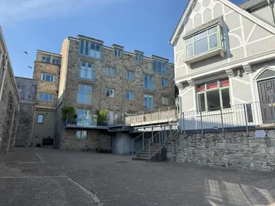 a large brick building with a staircase in front of it at 4 Sunday School Court in St Ives