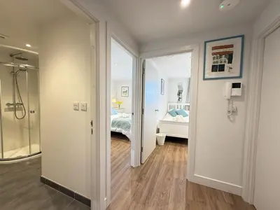 a bathroom with a walk in shower and a bedroom at 4 Sunday School Court in St Ives