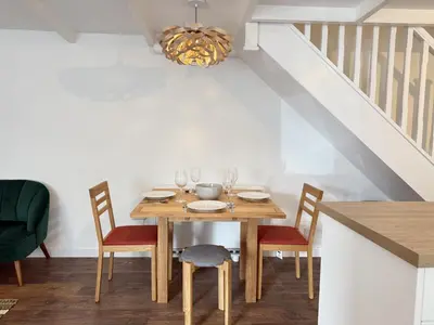 a dining room with a wooden table and chairs at An Argh Vyghan - the little ark in St Ives