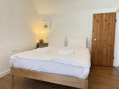 a bedroom with a large bed with two white pillows at An Argh Vyghan - the little ark in St Ives