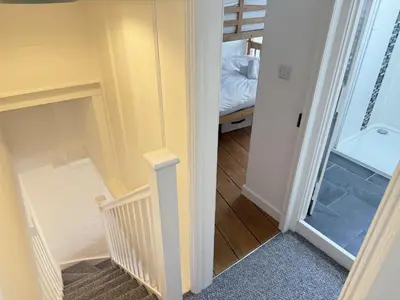 a hallway with a stairway leading to a bedroom at An Argh Vyghan - the little ark in St Ives