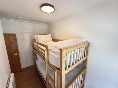 a bedroom with two bunk beds in a room at An Argh Vyghan - the little ark in St Ives