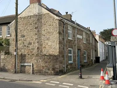 an old stone building on the side of a street at An Argh Vyghan - the little ark in St Ives