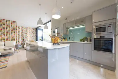 a kitchen with a counter with a bowl of fruit on it at Two Bare Feet in Truro