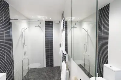a bathroom with a walk in shower and a toilet at Two Bare Feet in Truro