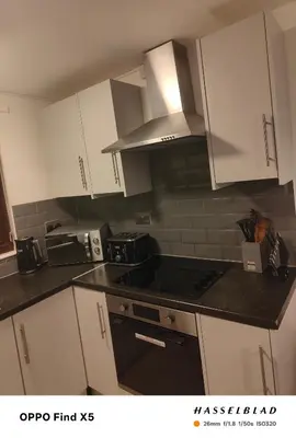 a kitchen with white cabinets and a stove top oven at 52 strawberry in Hayle