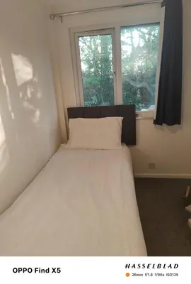 a bed in a room with a window at 52 strawberry in Hayle