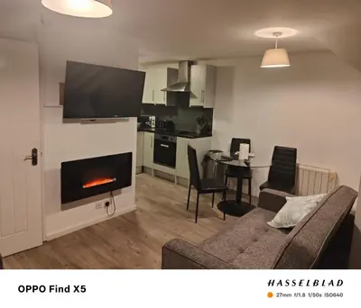 a living room with a couch and a fireplace at 52 strawberry in Hayle