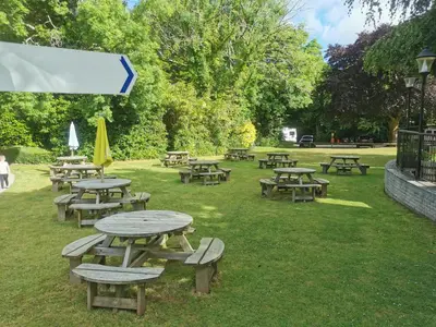a group of picnic tables and umbrellas in a park at 52 strawberry in Hayle