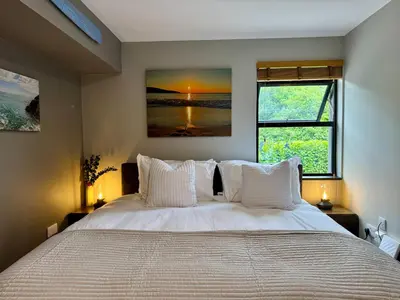 a bedroom with a large bed with white pillows at Uno Moor Side - 4 Bed, 2 Bath, Garden, sleeps 8 - Parking in Carbis Bay