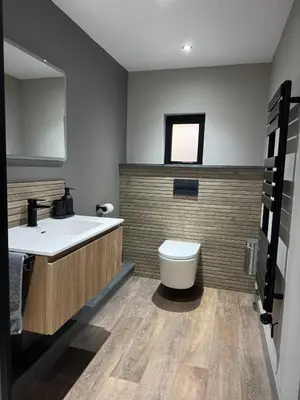 a bathroom with a white sink and a toilet at Uno Moor Side - 4 Bed, 2 Bath, Garden, sleeps 8 - Parking in Carbis Bay