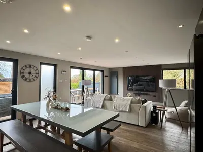 a living room with a table and a couch at Uno Moor Side - 4 Bed, 2 Bath, Garden, sleeps 8 - Parking in Carbis Bay