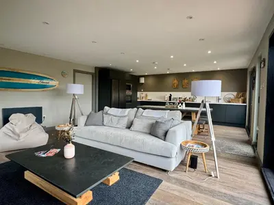 a living room with a couch and a kitchen at Uno Moor Side - 4 Bed, 2 Bath, Garden, sleeps 8 - Parking in Carbis Bay