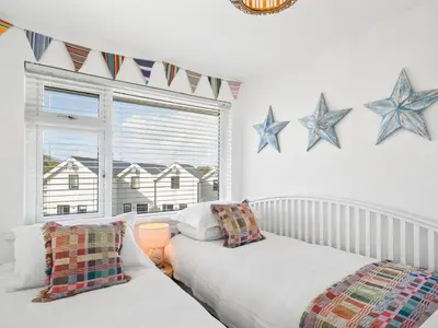 two beds in a room with stars on the wall at Liwus in Newquay