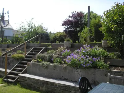 a garden with a bunch of flowers and stairs at Cottage On The Square in Camelford