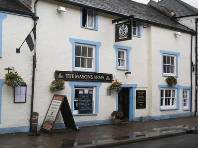 a large white building with a clock on it at Cottage On The Square in Camelford