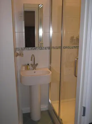 a bathroom with a sink and a shower at Cottage On The Square in Camelford