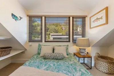 a bedroom with a bed and a window at High Tide Bedford Rd Boutiques in St Ives