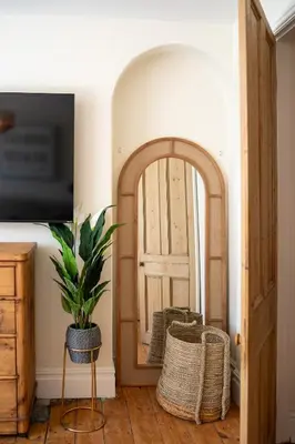 a room with a door and a potted plant in front at Low Tide Bedford Rd Boutiques in St Ives