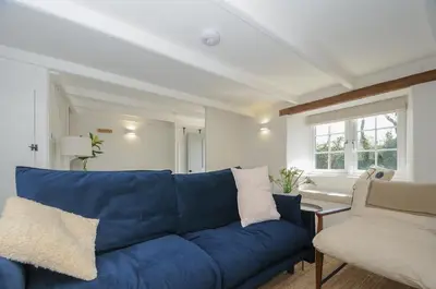 a blue couch and a chair in a living room at Sunrise Cottage in Bodmin