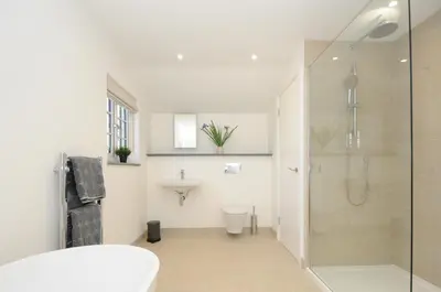 a bathroom with a shower and a toilet and a sink at Sunrise Cottage in Bodmin