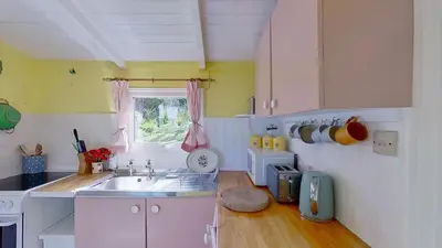 a small kitchen with a sink and a window at B18 Sandford, Riviere Towans in Hayle