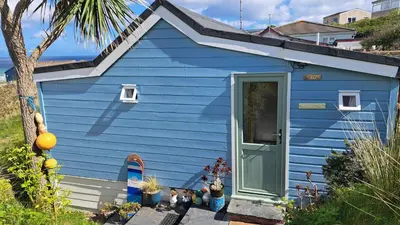 a blue tiny house with a blue door at B18 Sandford, Riviere Towans in Hayle