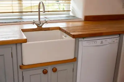 a kitchen with a sink and a window at Stylish Cottage - Walk to Beach & Pubs & Fast WiFi in St. Agnes