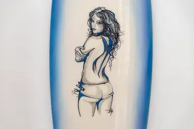 a drawing of a woman in a bikini on a plate at Stylish Cottage - Walk to Beach & Pubs & Fast WiFi in St. Agnes