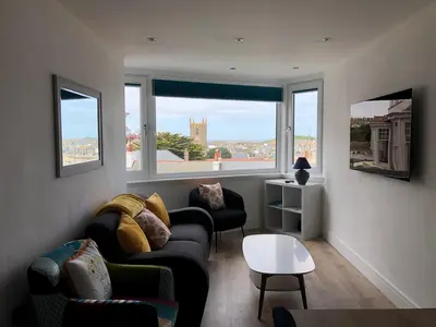 a living room with two couches and two windows at Dixies View - 2 bed apartment - Central St Ives in St Ives