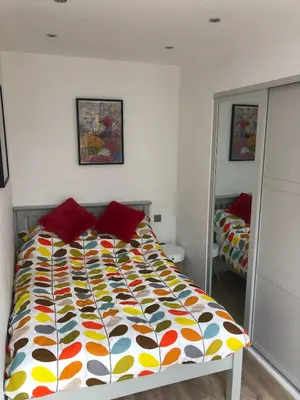 a bed with a colorful comforter in a bedroom at Dixies View - 2 bed apartment - Central St Ives in St Ives
