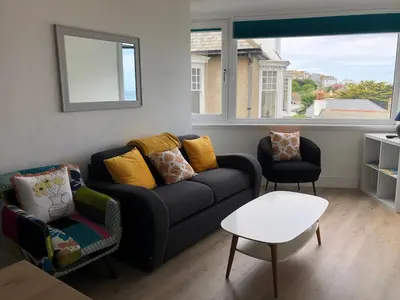 a living room with a couch and two chairs at Dixies View - 2 bed apartment - Central St Ives in St Ives