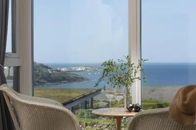 a room with a table and a view of the ocean at Spectacular Sea Views, Wi-Fi, Parking in Carbis Bay