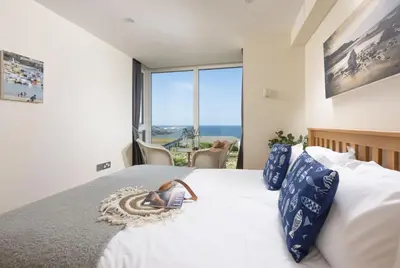 a bedroom with a bed with a view of the ocean at Spectacular Sea Views, Wi-Fi, Parking in Carbis Bay
