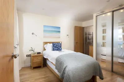 a bedroom with a bed and a walk in shower at Spectacular Sea Views, Wi-Fi, Parking in Carbis Bay