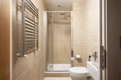 a bathroom with a shower and a toilet and a sink at Spectacular Sea Views, Wi-Fi, Parking in Carbis Bay