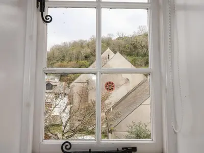 a window in a room with a view of a building at Teana Cottage in Looe